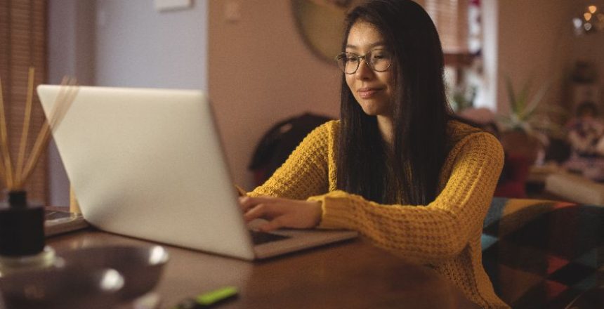 woman-using-laptop-table-living-room